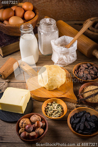 Image of Assortment of baking ingredients and kitchen utensils in vintage wooden style