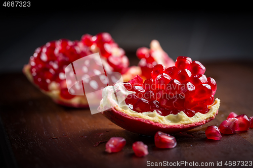 Image of Fresh organic pomegranate on wooding cutting board