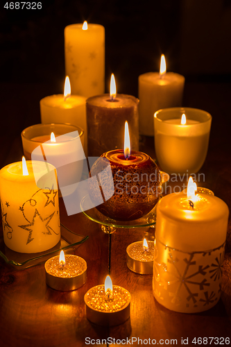 Image of Candles on wooden background. Candlelights for Christmas.