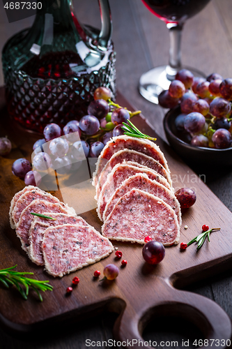 Image of Saltufo - Italian salami delicacy, salami with summer truffle coated with Parmesan cheese with red wine and grapes