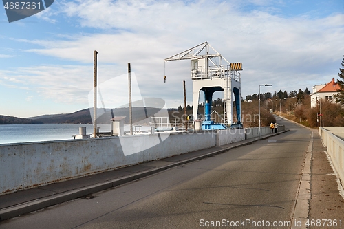 Image of Dam and crane structure on a reservoir