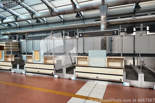 Image of Check-in counters and baggage conveyors at an airport