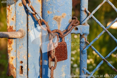 Image of Old gate with padlock and chain