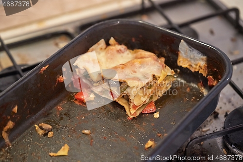 Image of Lasagna leftover in a dirty kitchen