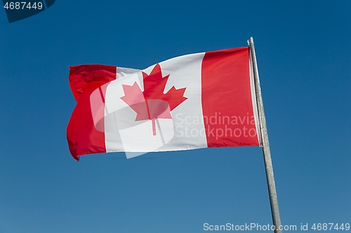 Image of Canadian Flag Against Blue Sky