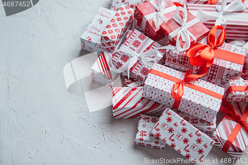 Image of A pile various size wrapped in festive paper boxed gifts placed on stack. Christmas concept