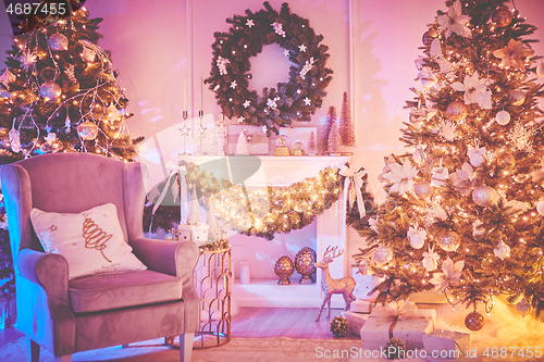 Image of Beautiful Christmas interior decoration for family celebration with pine tree, armchair, fireplace