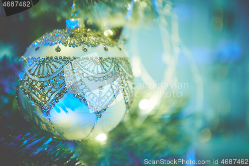 Image of Colorful christmas ornaments and decorations hanging from christmas tree