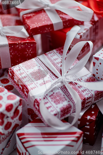 Image of Christmas concept. Close up on festive paper wrapped gifts with ribbon