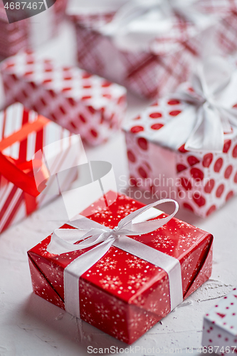 Image of Christmas concept. Close up on festive paper wrapped gifts with ribbon