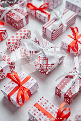 Image of Colorful white and red Christmas theme. Wrapped gifts in festive paper with ribbon