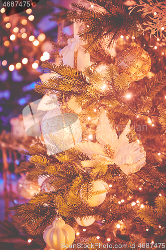 Image of Colorful christmas ornaments and decorations hanging from christmas tree