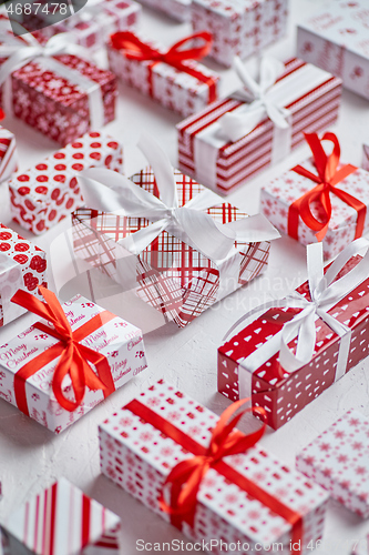 Image of Colorful white and red Christmas theme. Wrapped gifts in festive paper with ribbon