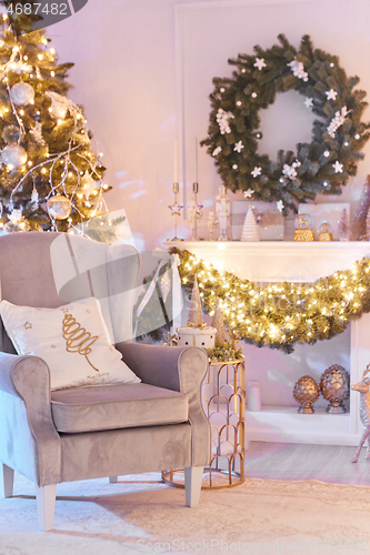 Image of Beautiful Christmas interior decoration for family celebration with pine tree, armchair, fireplace