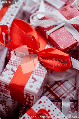 Image of Christmas concept. Close up on festive paper wrapped gifts with ribbon