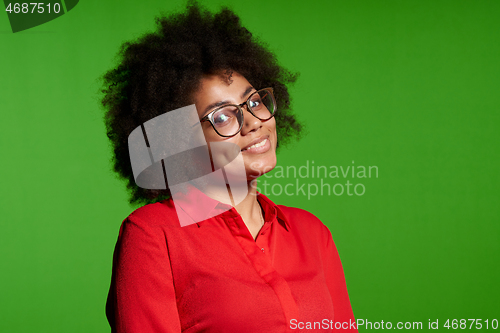 Image of Smiling young African-American girl in glasses and red shirt looking at camera