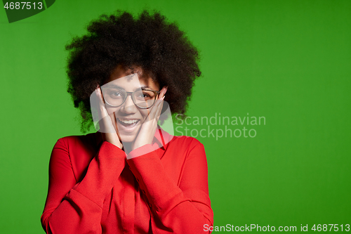 Image of Happy excited young African-American girl looking at camera screaming with hands on cheeks