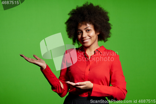 Image of Smiling young African-American girl in glasses and red shirt looking at camera