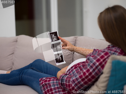 Image of pregnant woman looking baby\'s ultrasound