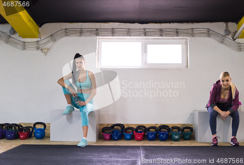 Image of young athletes women sitting and relaxing