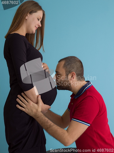 Image of pregnant couple  isolated over blue background