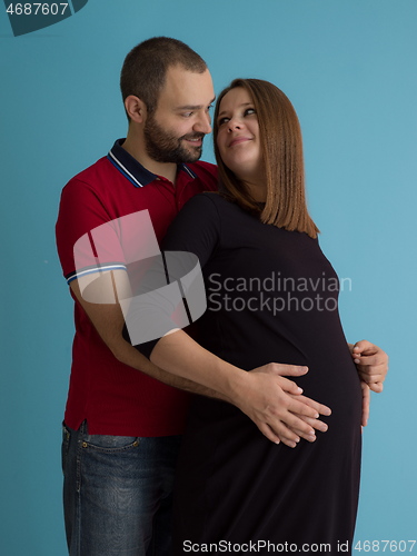 Image of pregnant couple  isolated over blue background