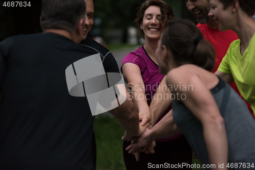 Image of runners giving high five to each other