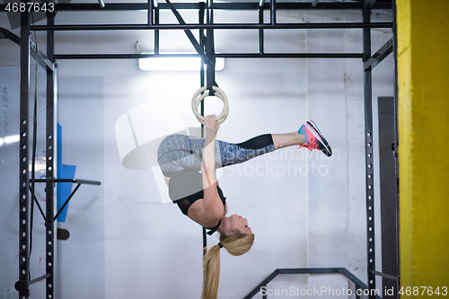 Image of woman working out on gymnastic rings