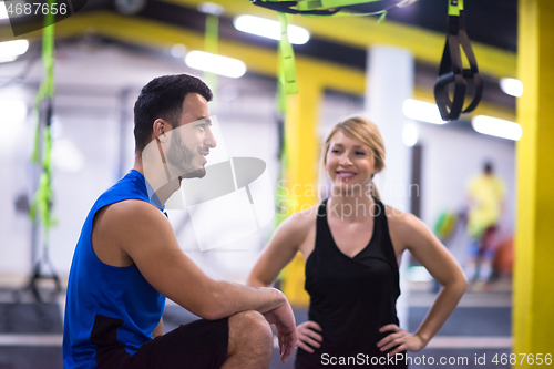 Image of athletes working out  jumping on fit box