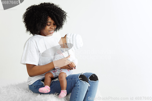 Image of Portrait of beautiful african woman holding on hands her little baby