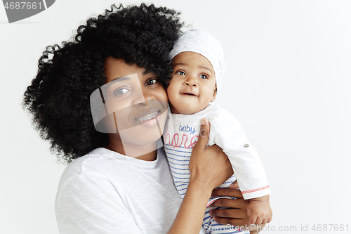 Image of Portrait of beautiful african woman holding on hands her little baby