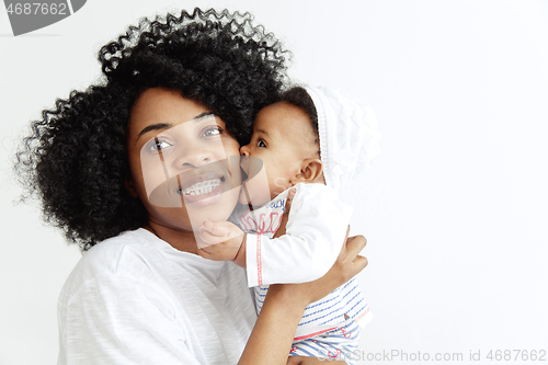 Image of Portrait of beautiful african woman holding on hands her little baby