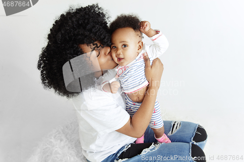 Image of Portrait of beautiful african woman holding on hands her little baby