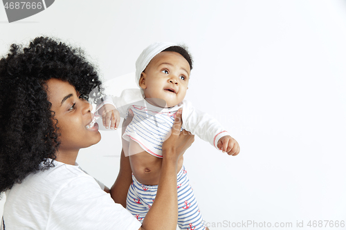 Image of Portrait of beautiful african woman holding on hands her little baby