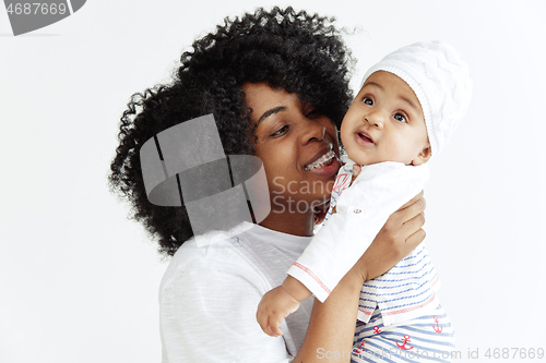 Image of Portrait of beautiful african woman holding on hands her little baby