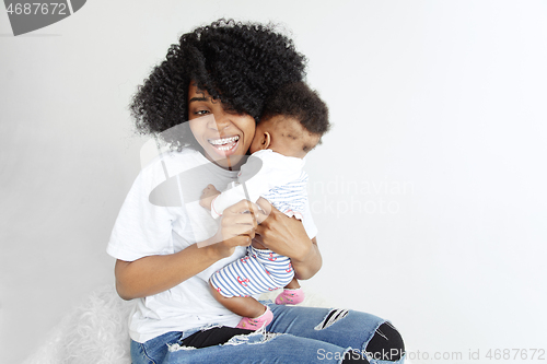 Image of Portrait of beautiful african woman holding on hands her little baby