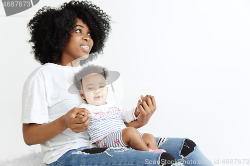 Image of Portrait of beautiful african woman holding on hands her little baby