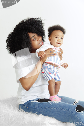 Image of Portrait of beautiful african woman holding on hands her little baby