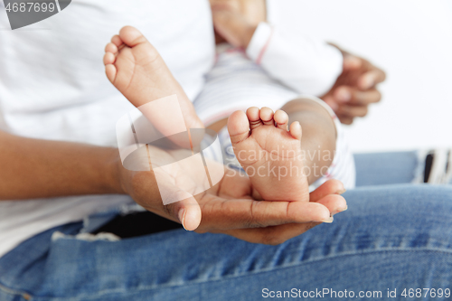 Image of Portrait of beautiful african woman holding on hands her little baby