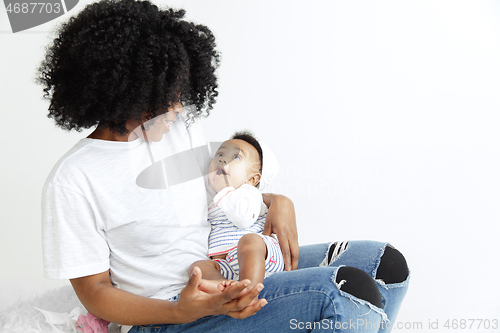 Image of Portrait of beautiful african woman holding on hands her little baby