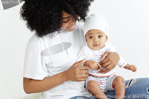 Image of Portrait of beautiful african woman holding on hands her little baby