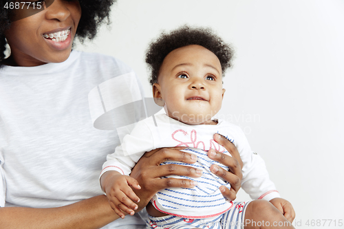 Image of Portrait of beautiful african woman holding on hands her little baby