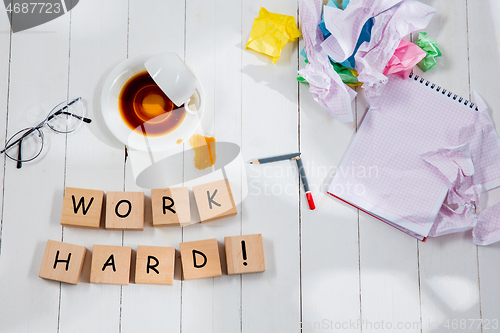 Image of HARD WORK. Message in wooden cubes on a desk background.