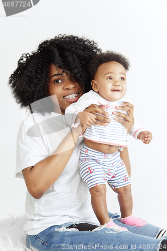 Image of Portrait of beautiful african woman holding on hands her little baby