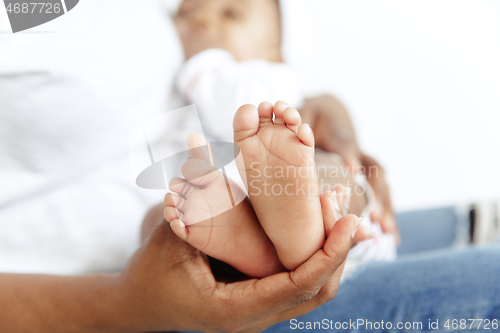 Image of Portrait of beautiful african woman holding on hands her little baby