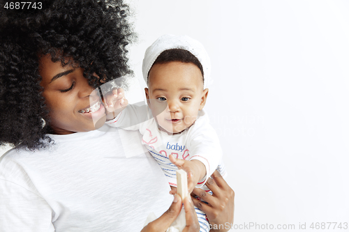 Image of Portrait of beautiful african woman holding on hands her little baby