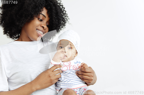 Image of Portrait of beautiful african woman holding on hands her little baby