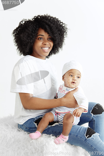 Image of Portrait of beautiful african woman holding on hands her little baby