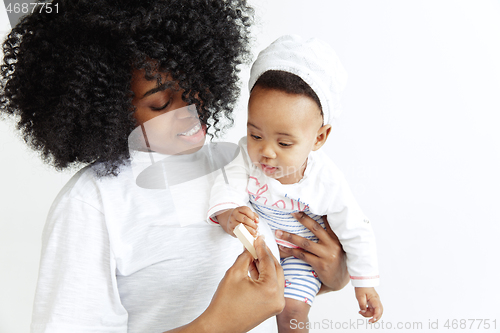 Image of Portrait of beautiful african woman holding on hands her little baby