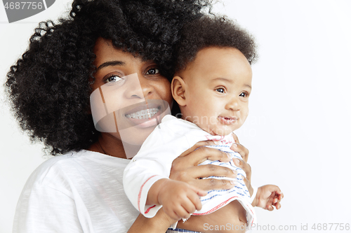 Image of Portrait of beautiful african woman holding on hands her little baby